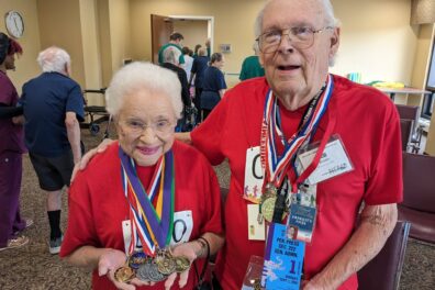 Seniors displaying medals from the Senior Olympics