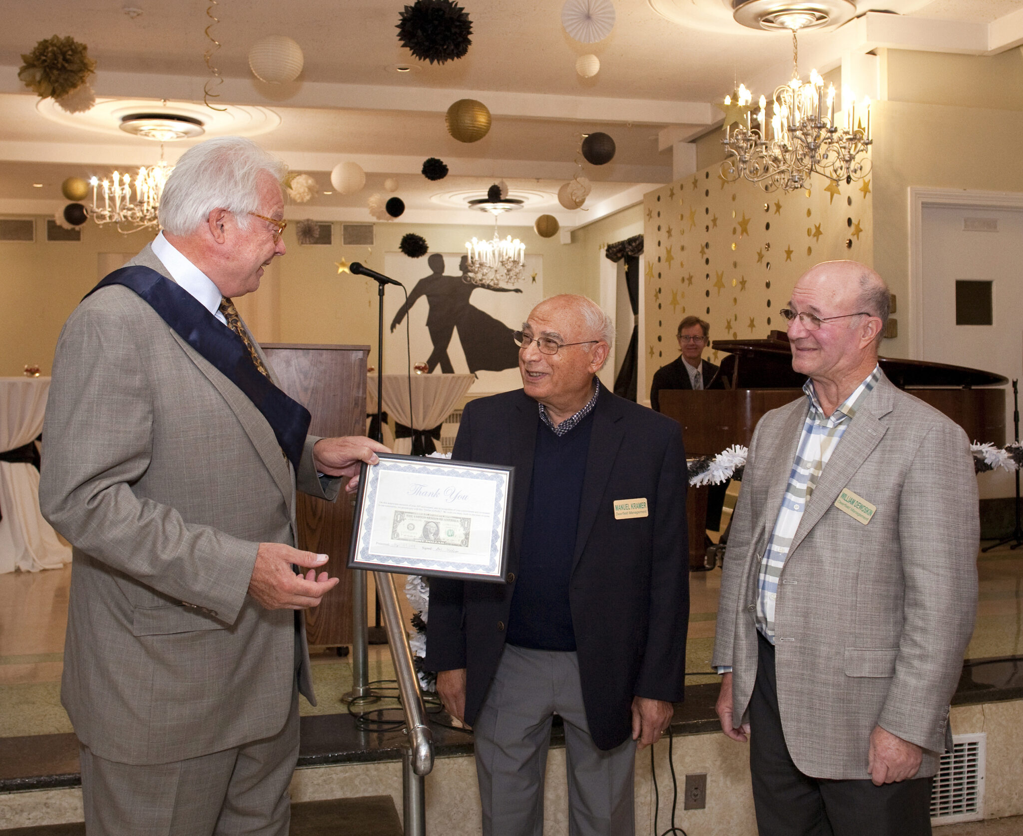 The Kenwood Senior Living owners receiving a plaque from the Chamber of Commerce